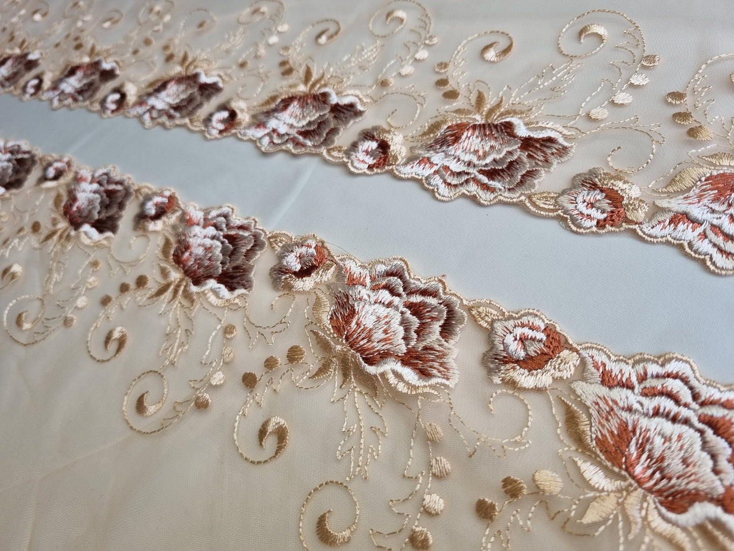 Beige tule kant met geborduurde bordeaux met witte roosjes