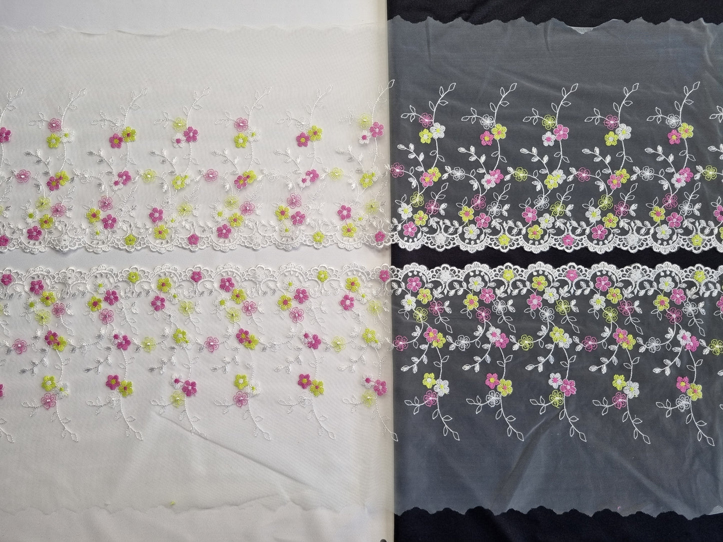 Wit tule kant met kleine geborduurde bloemetjes in wit, fuchsia en lime.