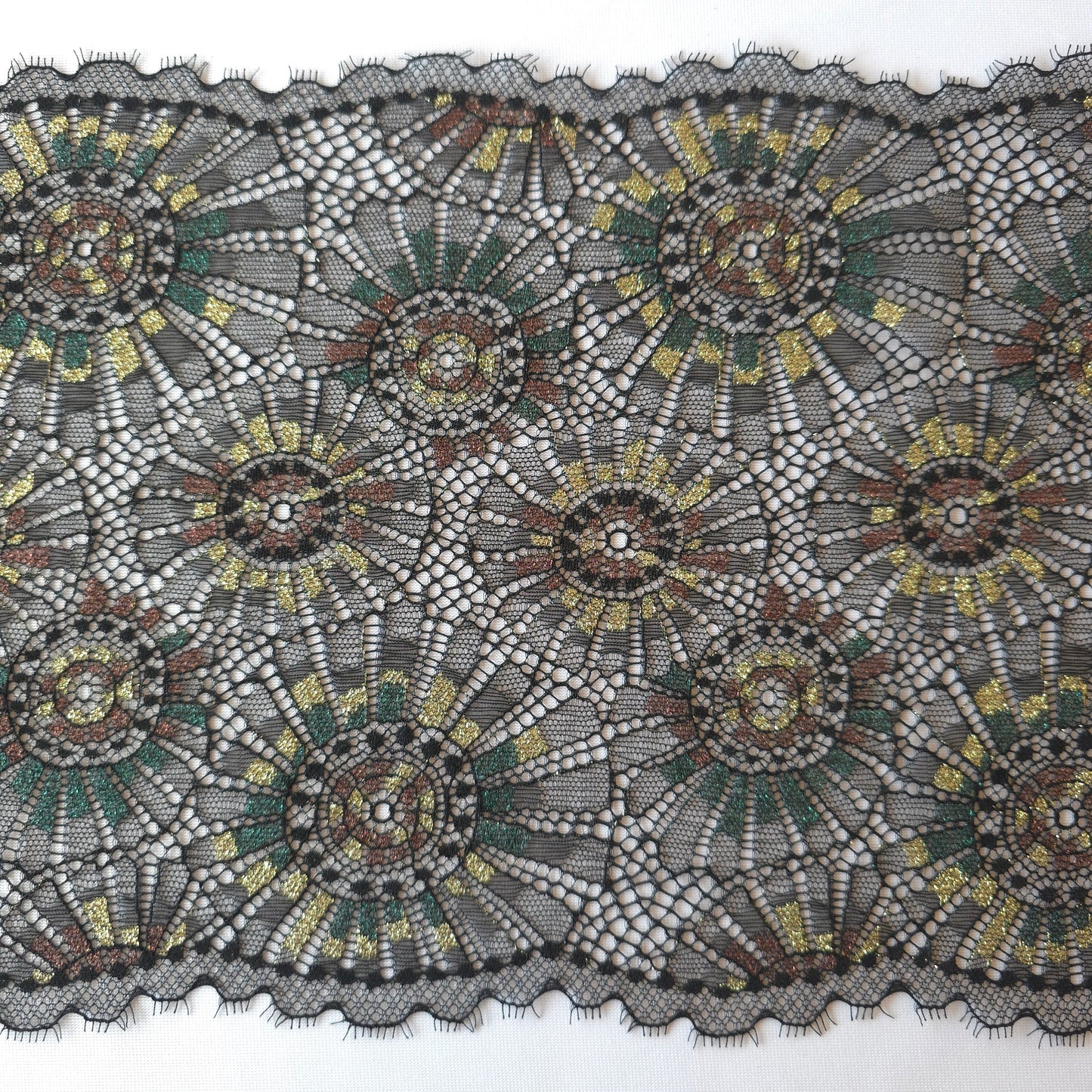 2025-101 zwart stretchkant met abstract vuurwerk voorzien van lurexgaren in goud, groen en bruin