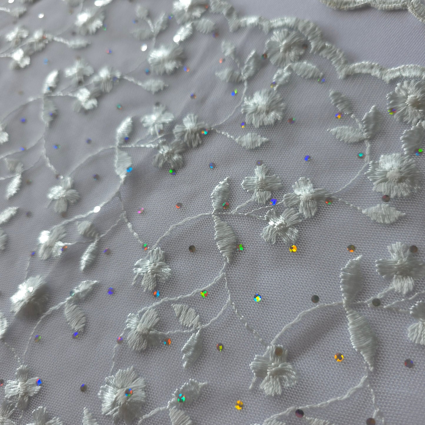 2026-73 zilvergrijs tule kant met iriserende polkadotjes van folie