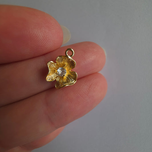 goudkleurig bloemetje met zirkoontje